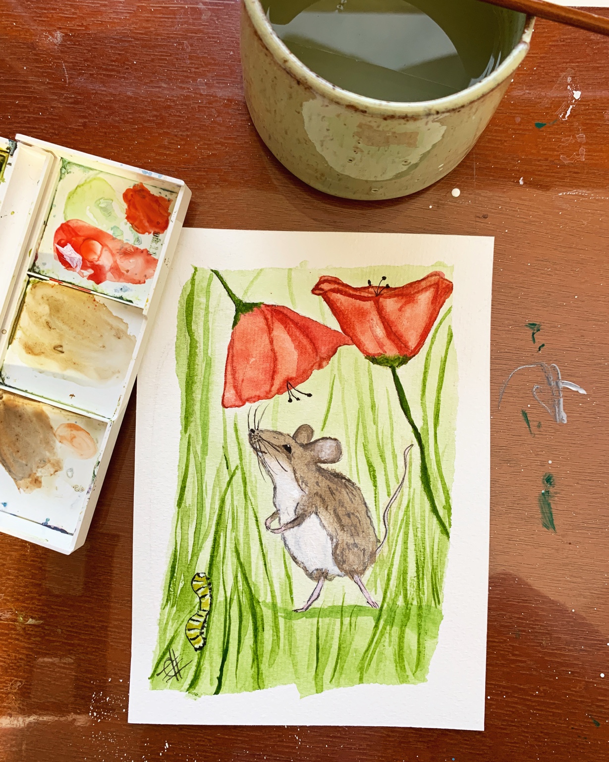 Mouse beneath red watercolor poppies